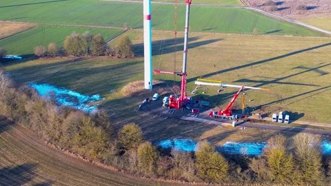 Aerial view of wind turbine construction site with cranes and service vehicles Stock Footage 328266912