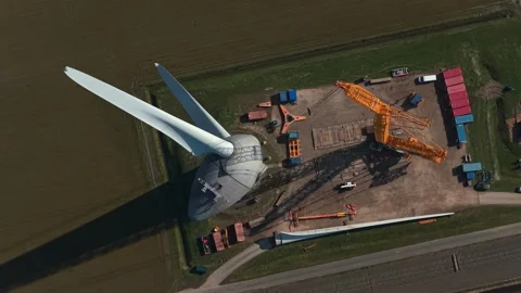 Aerial view of wind turbine construction and blade assembly process Stock Footage 332850359