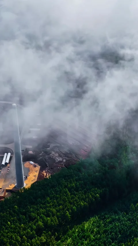 Aerial View Of Wind Turbine Construction Site Through Thick Low Clouds Stock Footage 336231687