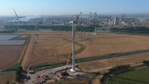 Aerial view of wind turbine construction site with heavy crane Stock Footage 342811192