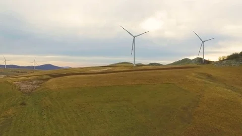 Aerial View of Wind Turbine Fields with cloudy sky in the background Stock Footage 82331171