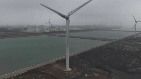 Aerial view of wind turbine generating renewable energy Видео 334032063