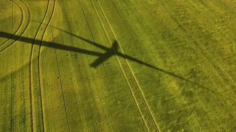 Aerial view of wind turbine shadow on field in Canada. Video stock 341954695