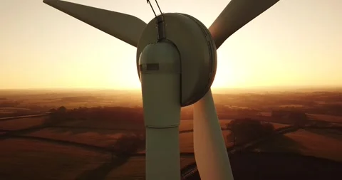 Aerial view of wind turbine at sunset in Devon, United Kingdom. Video stock 345082859