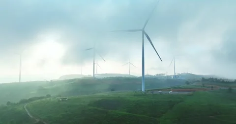 Aerial view of Wind turbines amidst misty landscape at sunset in Da lat, Vietnam Stock Footage 342467406