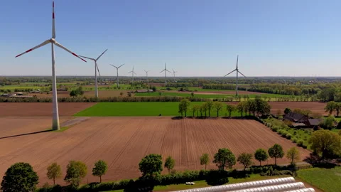 Aerial view of wind turbines and greenhouse complex. Drone landscape Stock Footage 337654458