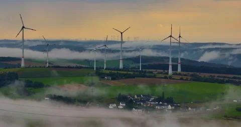 Aerial view of wind turbines in corn fields in Germany. Clouds over a green Stock Footage 252944965