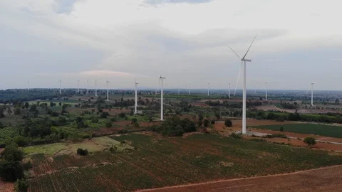 Aerial view of wind turbines on the fields Power generation using energy from cl Stock Footage 119425757