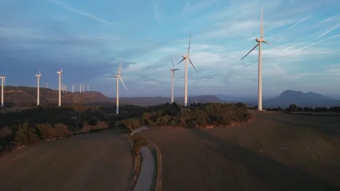Aerial view of wind turbines generating clean energy at sunset Stock Footage 331633802