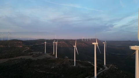 Aerial view of wind turbines generating renewable energy at sunset Stock Footage 331634072