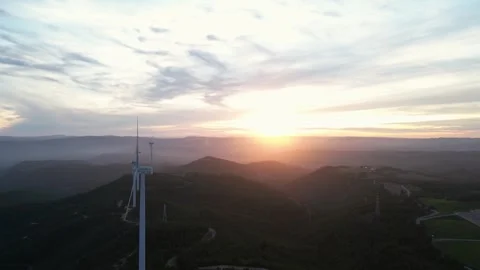 Aerial view of wind turbines generating renewable energy at sunset Stock Footage 331634252