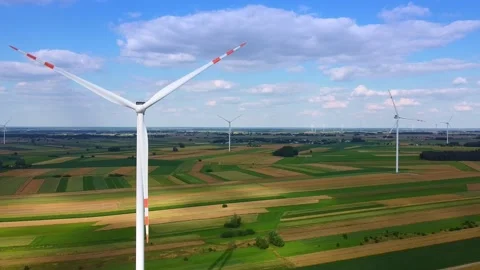 Aerial view of wind turbines operating over rural farmland Video stock 342591343