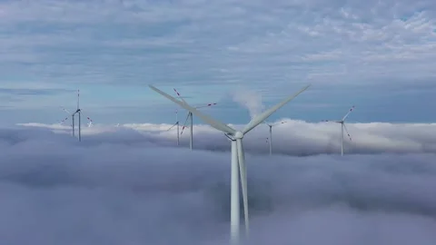Aerial view of wind turbines over clouds Video stock 133554752