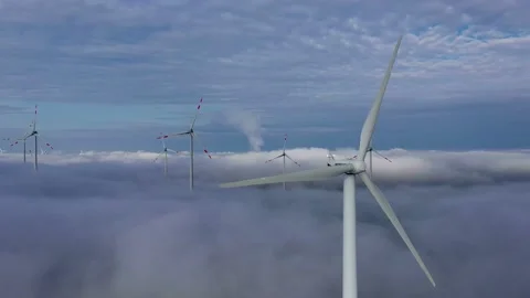 Aerial view of wind turbines over clouds Video stock 133556830