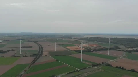 Aerial View Of Wind Turbines Over Fields With Roads And Clouds. Video stock 299059385