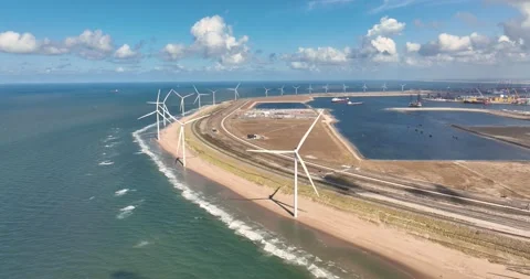 Aerial view of wind turbines on a sandy beach along the sea coast. Stock Footage 327798039