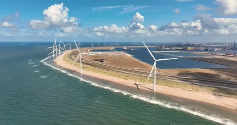 Aerial view of wind turbines on a sandy beach along the sea coast. Stock Footage 327798043