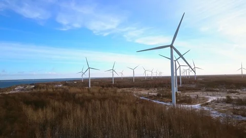 Aerial view of Wind turbines at sunset. Green clean renewable energy production Stock Footage 101077529