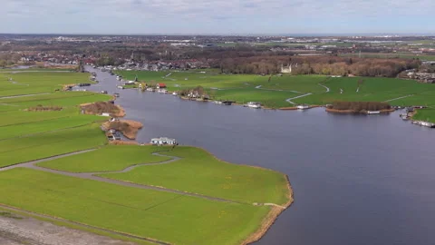 Aerial view of winding canal through green fields with drainage channels Stock Footage 336929936