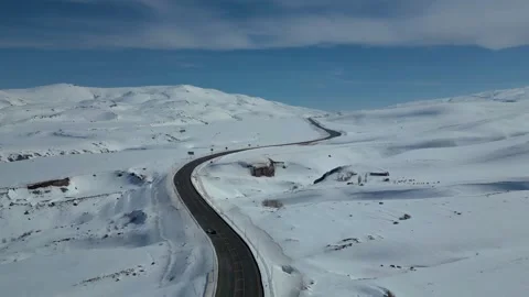 Aerial View of Winding Highway Through Snow-Covered Mountains 库存影片 330168325