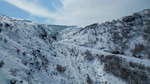 Aerial View of Winding Highway Through Snow-Covered Mountains 库存影片 330168379