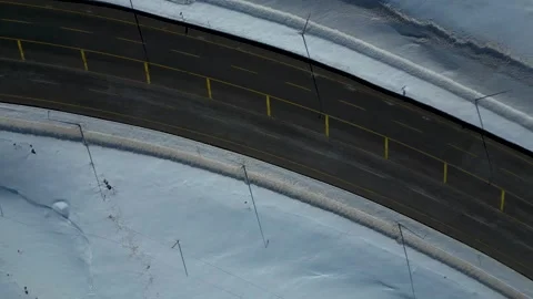 Aerial View of Winding Highway Through Snow-Covered Mountains 库存影片 330168471
