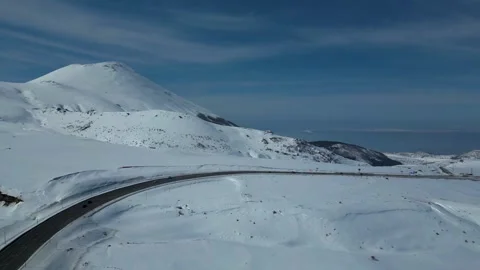 Aerial View of Winding Highway Through Snow-Covered Mountains 库存影片 330168933