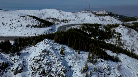 Aerial View of Winding Highway Through Snow-Covered Mountains 库存影片 330169145
