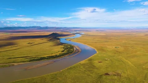Aerial view of winding long river wilderness clear sky plateau grassland scenery Stock Footage 337926494