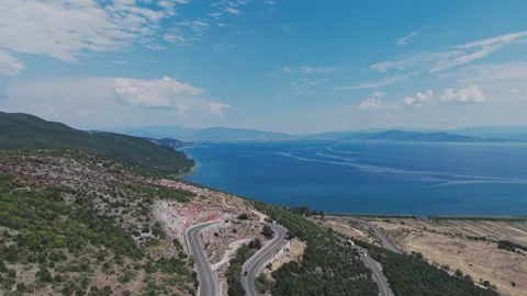Aerial view of the winding mountain road along the Albanian side of Lake Ohrid Stock Footage 345888637