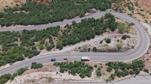 Aerial view of the winding mountain road along the Albanian side of Lake Ohrid Stock Footage 345889076