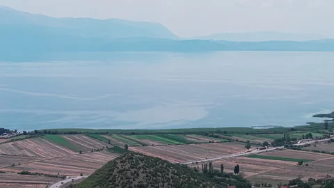 Aerial view of the winding mountain road along the Albanian side of Lake Ohrid Stock Footage 345889555
