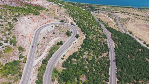 Aerial view of the winding mountain road along the Albanian side of Lake Ohrid Stock Footage 345889682