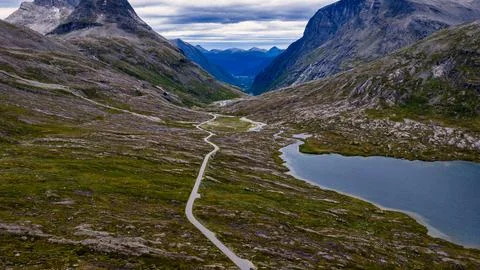 Aerial view of winding mountain road through alpine valley near Rauma, Norway Stock-Fotos