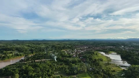 Aerial view of a winding muddy river flowing through a lush green landscape Stock Footage 333130612
