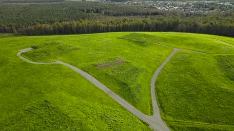 Aerial View of a Winding Path on a Former Garbage Dump Area Stock Footage 334066208