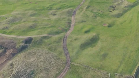 Aerial view of a winding path through green fields with varying textures an.. Stock Footage 269182840
