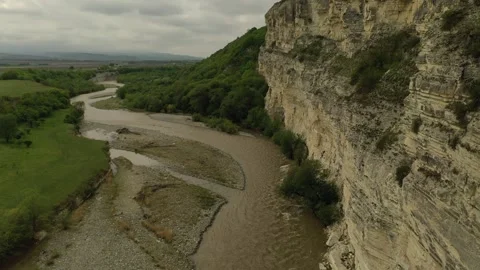 Aerial view of a winding river along dramatic limestone cliffs Stock Footage 338005717