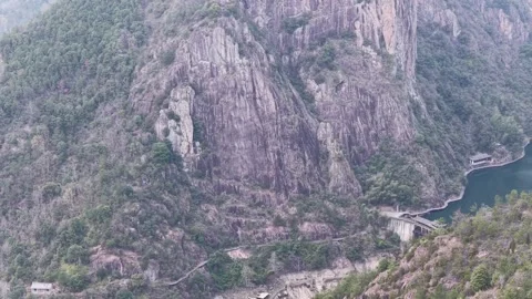 Aerial view winding river cuts through deep rugged canyon in Zhejiang China Stock Footage 336652077