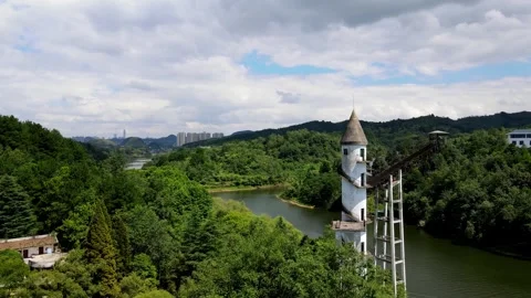 Aerial view of a winding river flowing through lush green hills and forest Video stock 342302067