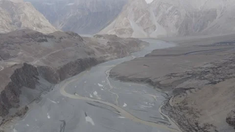 Aerial view of a winding river in the rugged mountains of Pakistan, highlighting 스톡 동영상 314456096