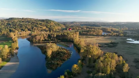 Aerial View of a Winding River Through an Autumn Valley Видео 283425172