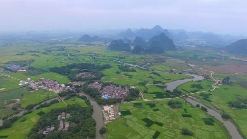 Aerial view of a winding river through green fields and village Video stock 311820191