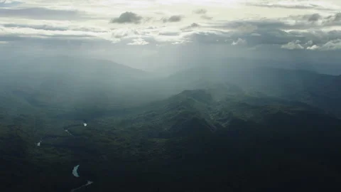 Aerial view of a winding river through a misty mountain forest 스톡 동영상 333201503