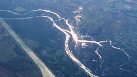Aerial View Of Winding River Through City With Bridges And Clouds Over Landscape Stock Footage 335383331