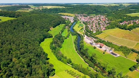 Aerial View of a Winding River Through a Scenic Valley with Vineyards 動画素材 338351858