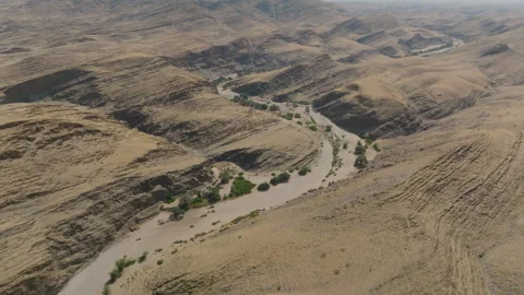 Aerial View Of Winding River Through Arid Namibia Desert Mountains Vídeo Stock 347126769