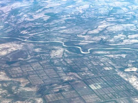 Aerial view of winding river through farmland Stock Photos