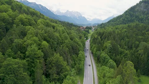 Aerial View of Winding Road Through Lush Green Forest in Austrian Alps 스톡 동영상 277802145