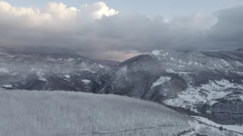 Aerial view of a winding road through a snowy forest. Stock Footage 310028370